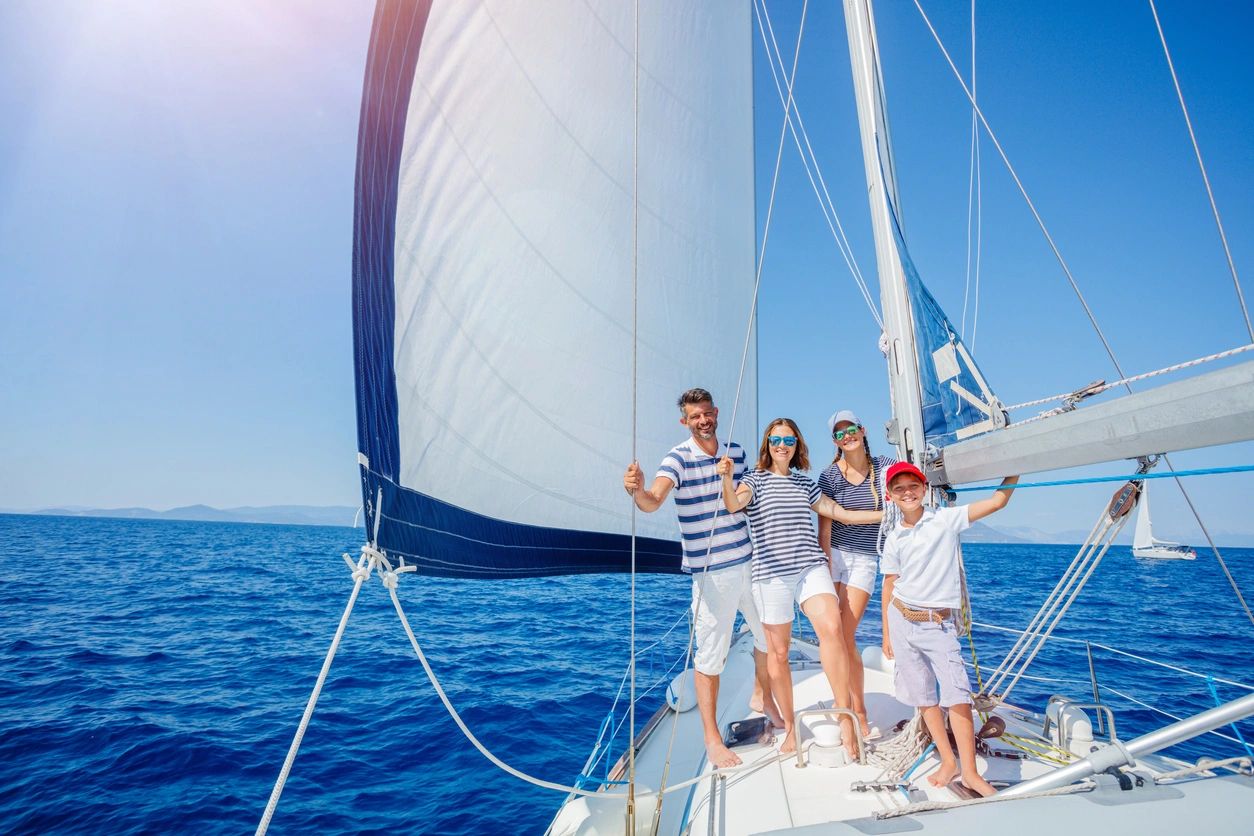 A group of people standing on top of a boat.