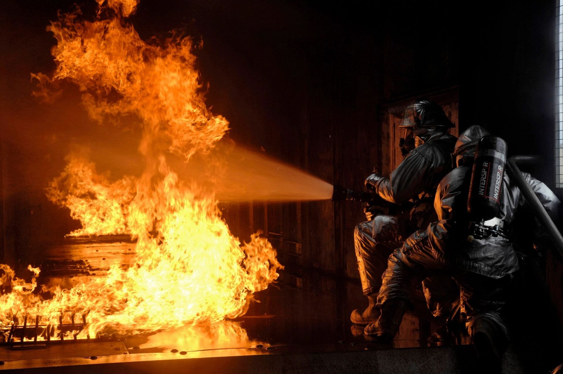 A group of people standing around a fire.