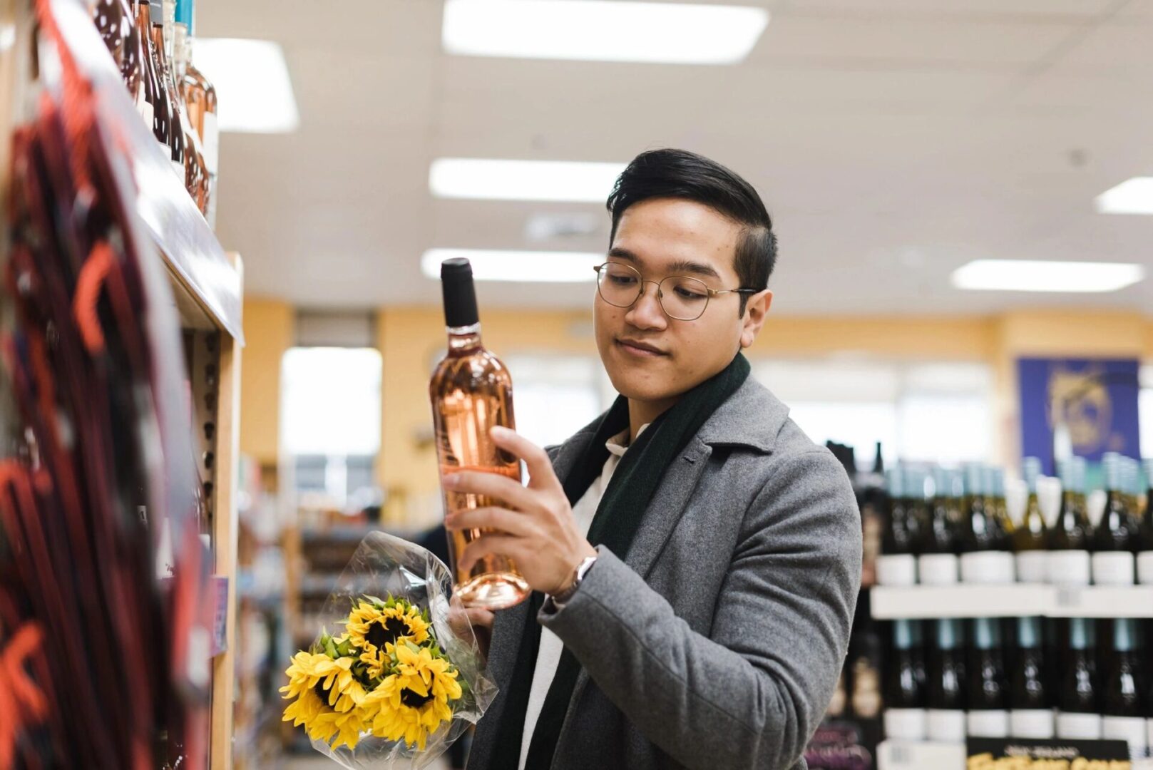 A man holding a bottle of wine in his hand.