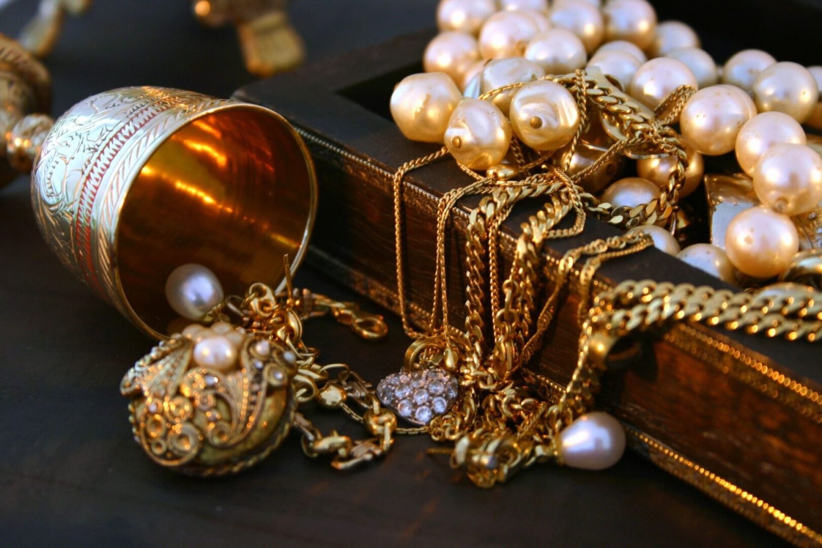 A bunch of gold jewelry on top of a table.