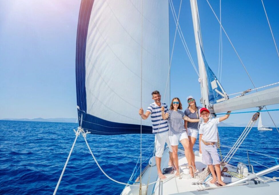 A group of people standing on top of a boat.