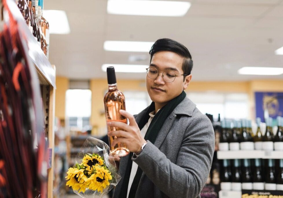 A man holding a bottle of wine in his hand.