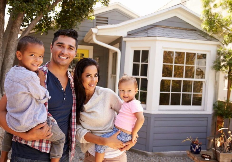 A family standing in front of their home.