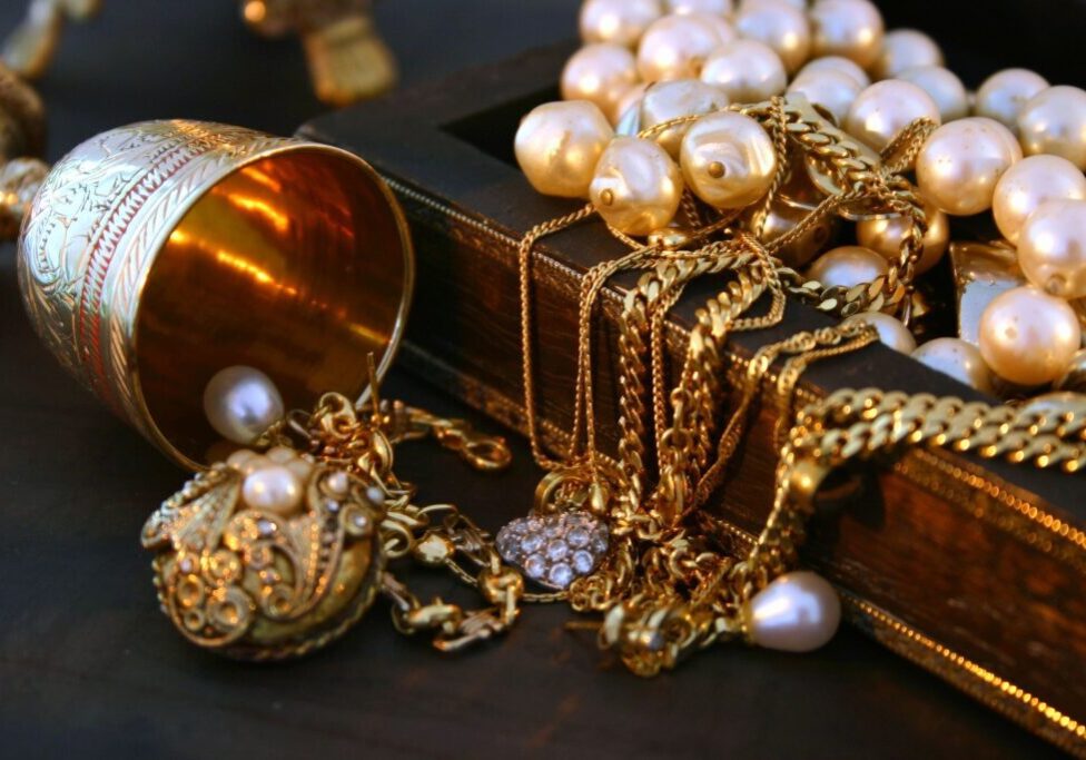 A bunch of gold jewelry on top of a table.