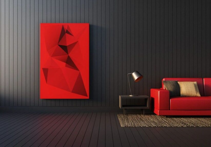 A red couch and lamp in a room.
