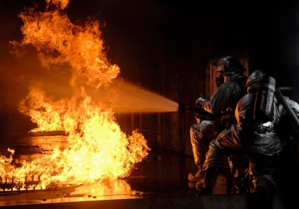 A group of people standing around a fire.